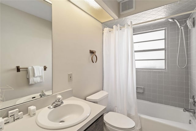 full bathroom featuring vanity, shower / bath combo, and toilet