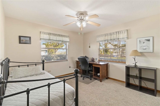 bedroom featuring light colored carpet and ceiling fan