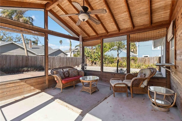 sunroom featuring lofted ceiling with beams and ceiling fan