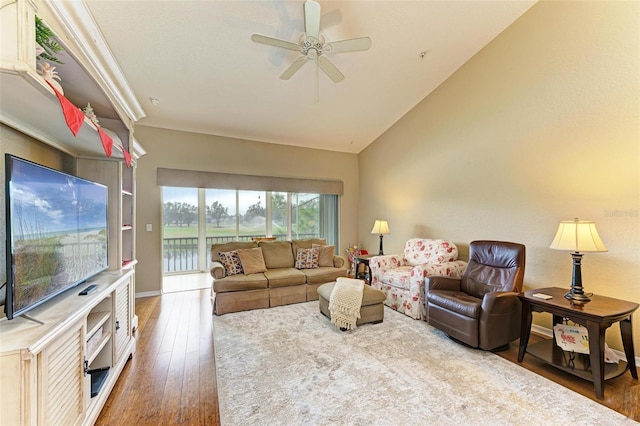 living room featuring ceiling fan, dark hardwood / wood-style flooring, a water view, and lofted ceiling