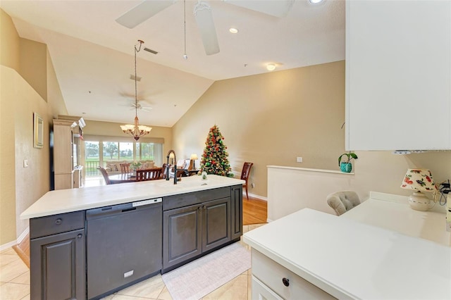 kitchen with sink, hanging light fixtures, stainless steel dishwasher, lofted ceiling, and ceiling fan with notable chandelier