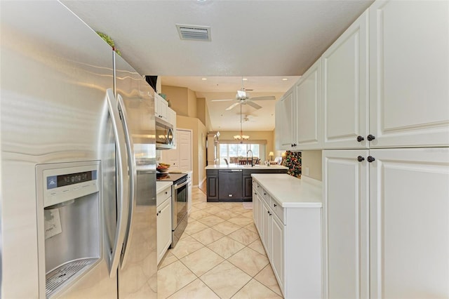 kitchen featuring light tile patterned floors, stainless steel appliances, white cabinetry, and ceiling fan