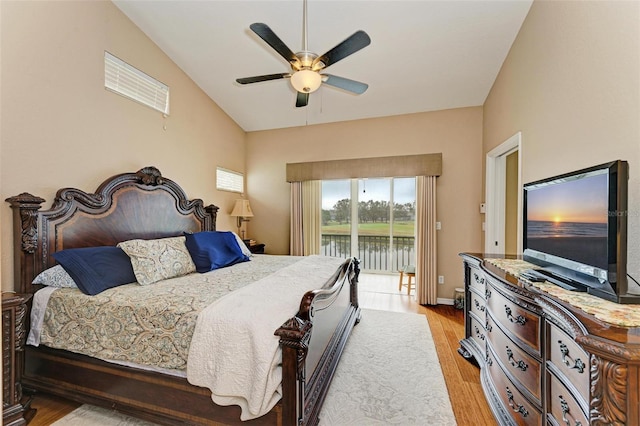 bedroom featuring access to outside, ceiling fan, light hardwood / wood-style flooring, and vaulted ceiling