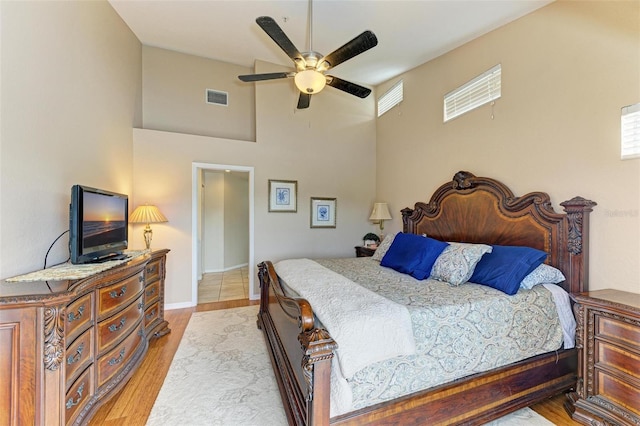 bedroom with light hardwood / wood-style floors and ceiling fan