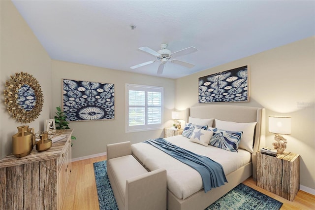 bedroom with ceiling fan and light hardwood / wood-style floors