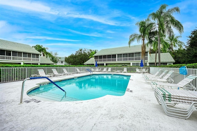 view of swimming pool featuring a sunroom