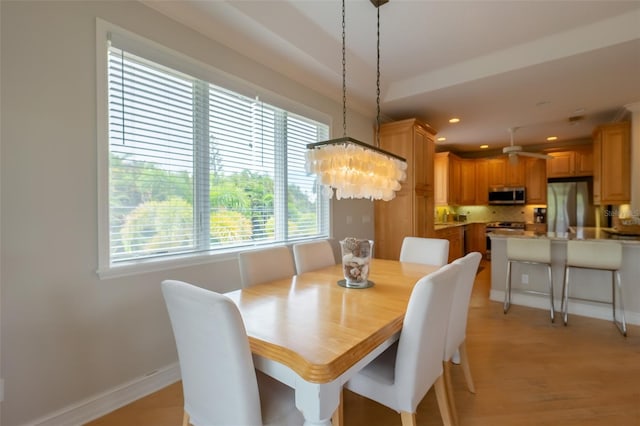 dining area featuring a chandelier and light wood-type flooring