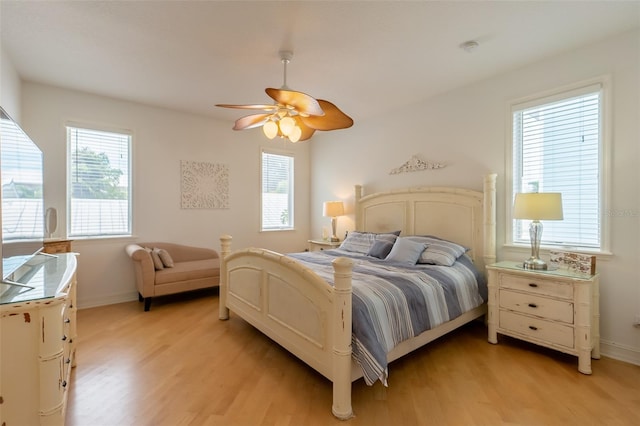 bedroom with light hardwood / wood-style flooring, multiple windows, and ceiling fan