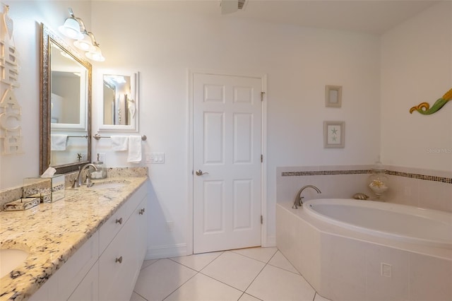 bathroom featuring tile patterned floors, vanity, and a relaxing tiled tub