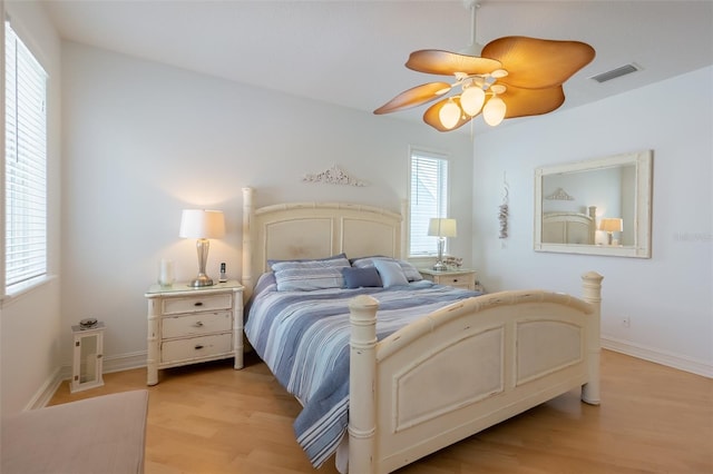 bedroom with ceiling fan and light wood-type flooring