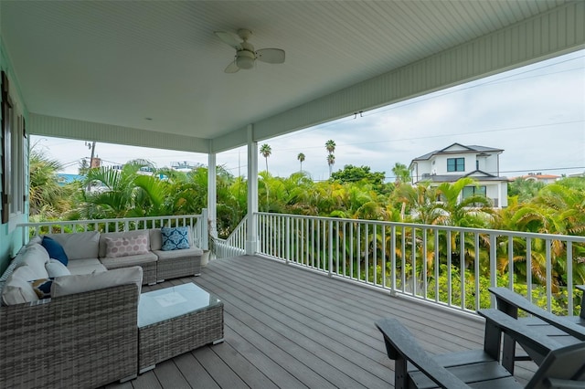 wooden terrace with ceiling fan and an outdoor living space