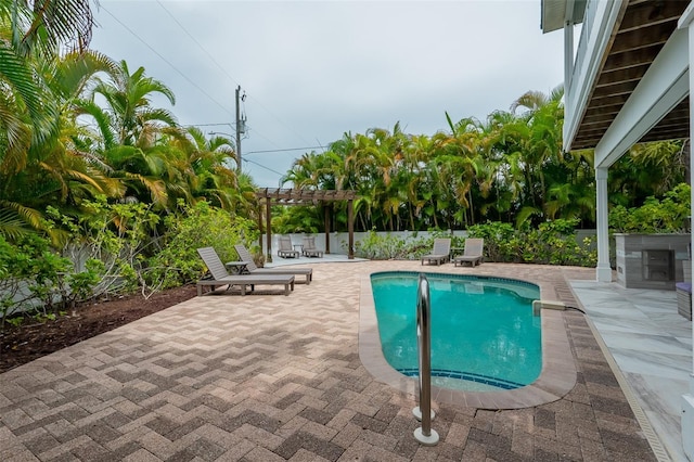 view of swimming pool featuring a pergola and a patio