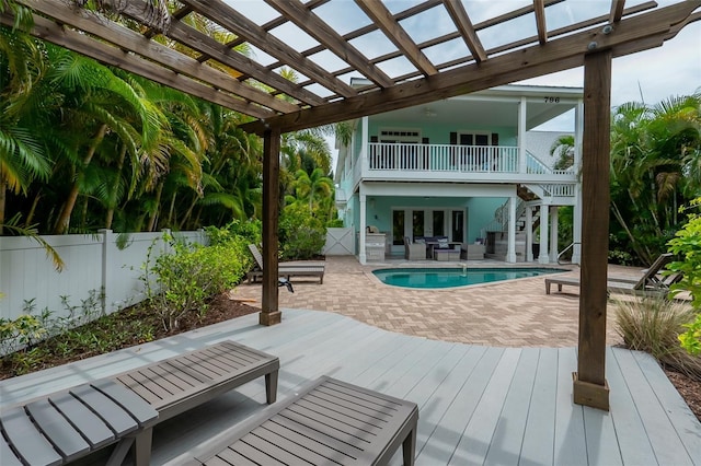 exterior space with french doors, a pergola, a balcony, a fenced in pool, and a patio area