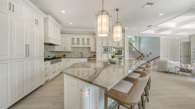 510 Bowsprit Ln, Longboat Key, FL 34228 - kitchen with stainless steel appliances, tasteful backsplash, a spacious island, recessed lighting, and light stone countertops