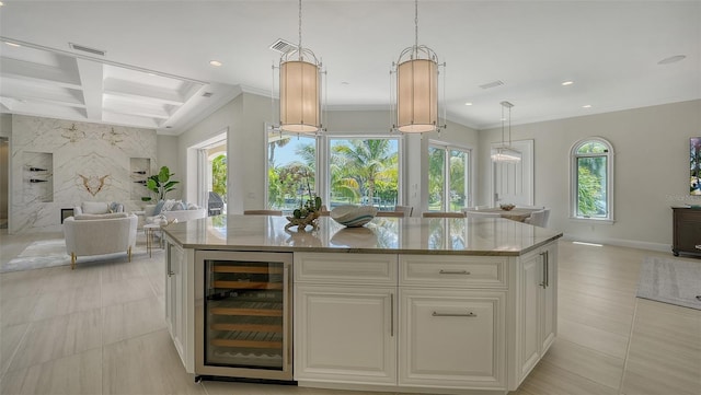 510 Bowsprit Ln, Longboat Key, FL 34228 - kitchen with wine cooler, open floor plan, light stone counters, recessed lighting, and a center island