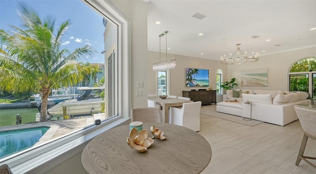 510 Bowsprit Ln, Longboat Key, FL 34228 - dining space featuring plenty of natural light, a chandelier, light tile patterned floors, crown molding, and recessed lighting
