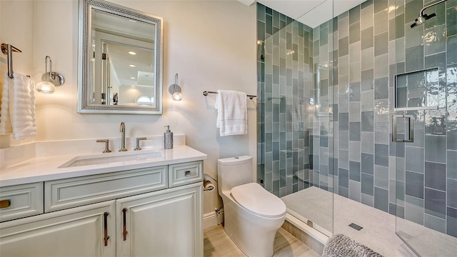 bathroom with vanity, toilet, and an enclosed shower