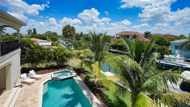 view of pool featuring an in ground hot tub and a patio