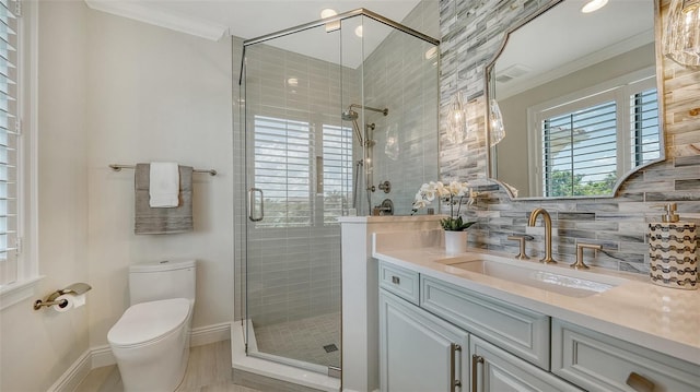 bathroom featuring crown molding, a shower with door, and vanity