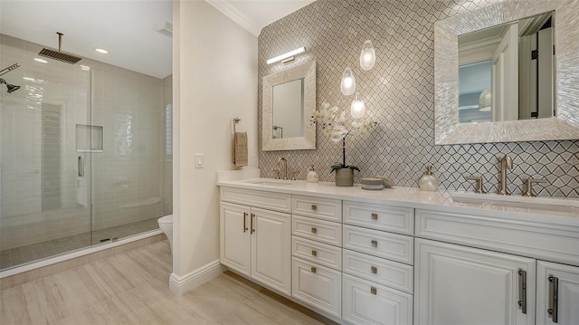 bathroom with an enclosed shower, toilet, decorative backsplash, vanity, and ornamental molding