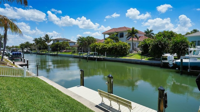 dock area with a water view and a yard