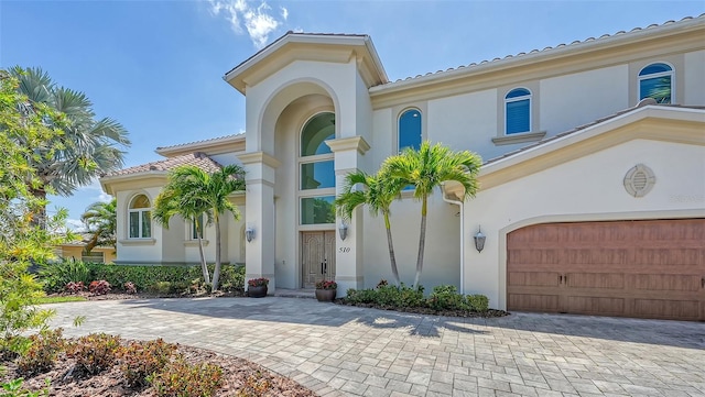 510 Bowsprit Ln, Longboat Key, FL 34228 - mediterranean / spanish-style house featuring stucco siding, a tiled roof, and decorative driveway