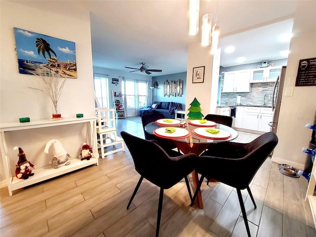 dining space featuring ceiling fan and light hardwood / wood-style flooring