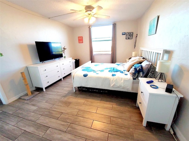 bedroom with dark hardwood / wood-style floors and ceiling fan