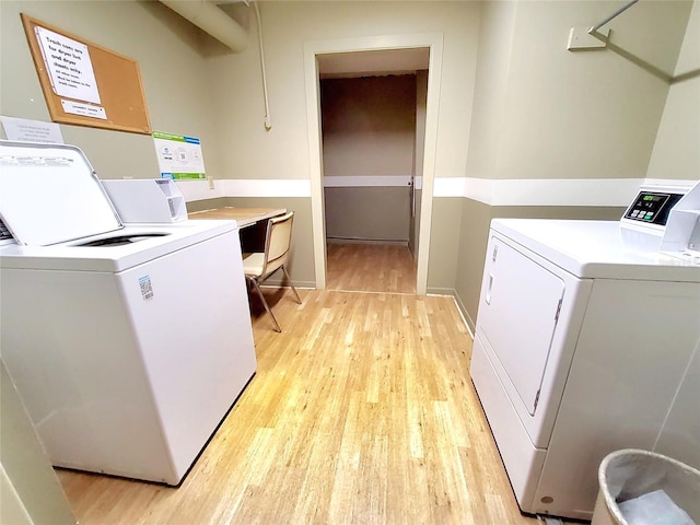 washroom featuring washer and dryer and light hardwood / wood-style flooring