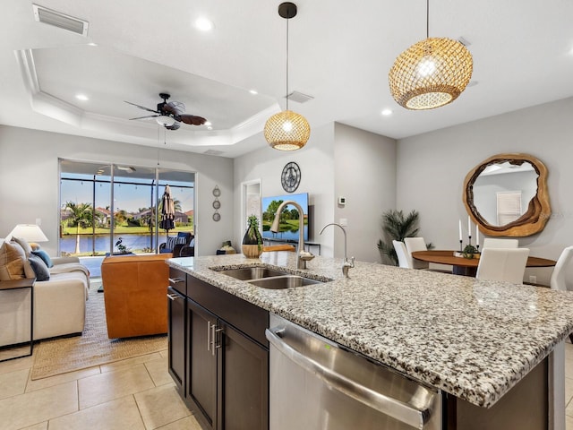 kitchen with a kitchen island with sink, dishwasher, ceiling fan, and hanging light fixtures