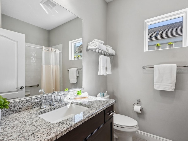 bathroom with vanity, toilet, and curtained shower