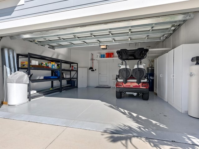 garage with water heater and a garage door opener