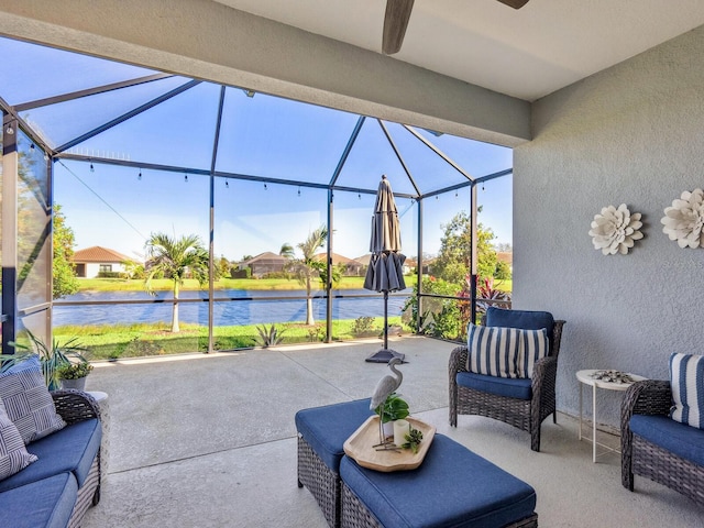 view of patio featuring glass enclosure and a water view