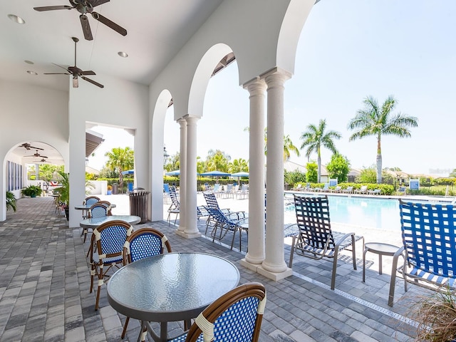 view of patio with ceiling fan and a community pool