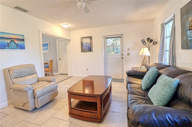 tiled living room featuring ceiling fan