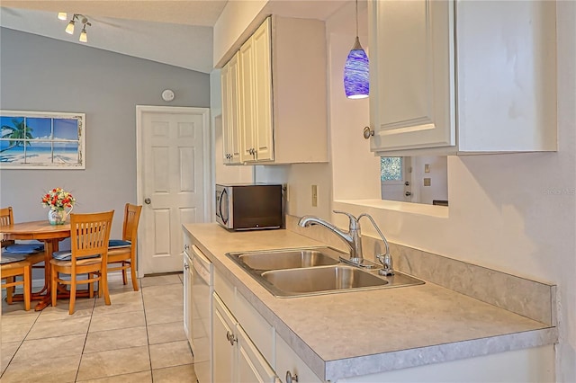 kitchen featuring vaulted ceiling, sink, dishwasher, white cabinetry, and hanging light fixtures