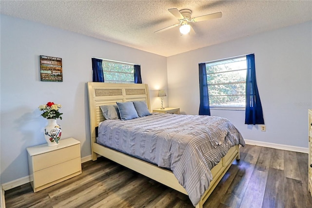 bedroom featuring a textured ceiling, dark hardwood / wood-style floors, and ceiling fan