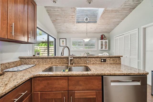 kitchen featuring stainless steel dishwasher, light stone countertops, lofted ceiling, and sink