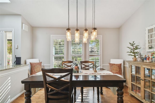 dining area with wood-type flooring