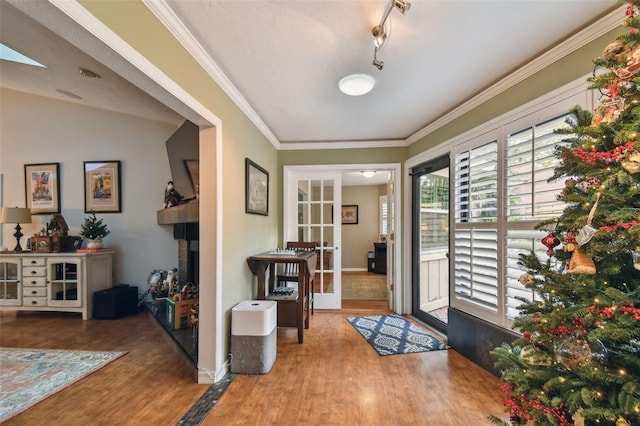 entryway with crown molding, french doors, wood-type flooring, and lofted ceiling