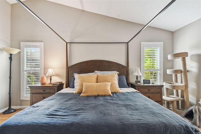 bedroom featuring hardwood / wood-style floors and vaulted ceiling