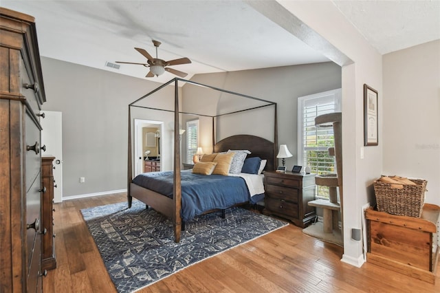 bedroom featuring ceiling fan, lofted ceiling, and hardwood / wood-style flooring