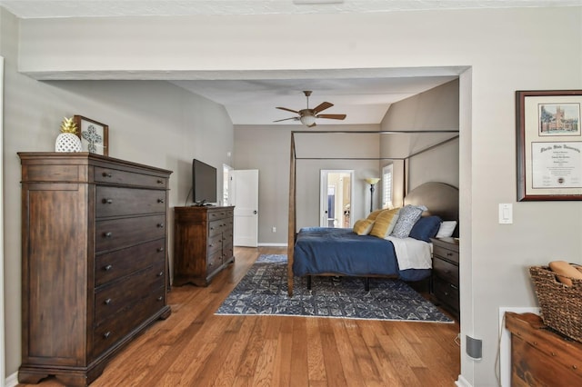 bedroom featuring hardwood / wood-style flooring, ceiling fan, and vaulted ceiling