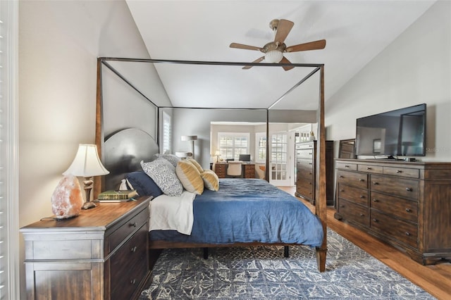 bedroom featuring ceiling fan, dark hardwood / wood-style flooring, and vaulted ceiling