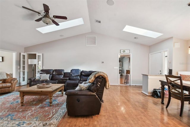 living room featuring wood-type flooring, french doors, ceiling fan, and lofted ceiling