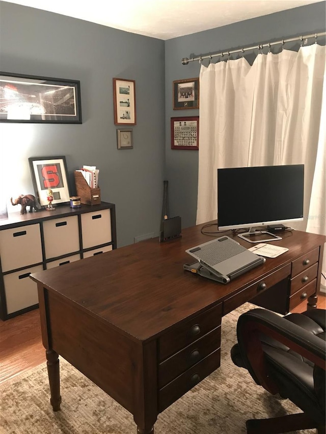 office with light hardwood / wood-style flooring