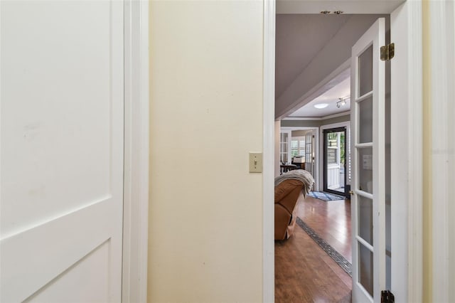 corridor featuring wood-type flooring, french doors, and crown molding