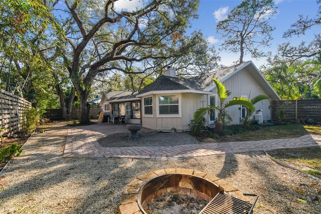 back of house featuring a patio and an outdoor fire pit