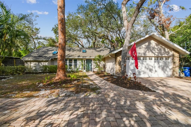 view of front facade featuring decorative driveway and an attached garage