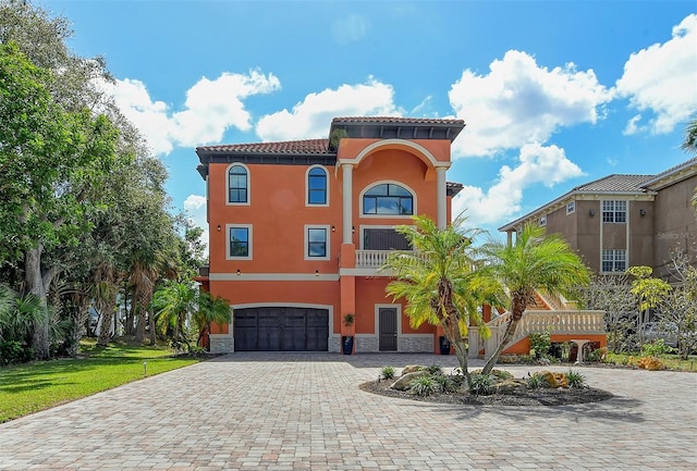 mediterranean / spanish-style home with a garage